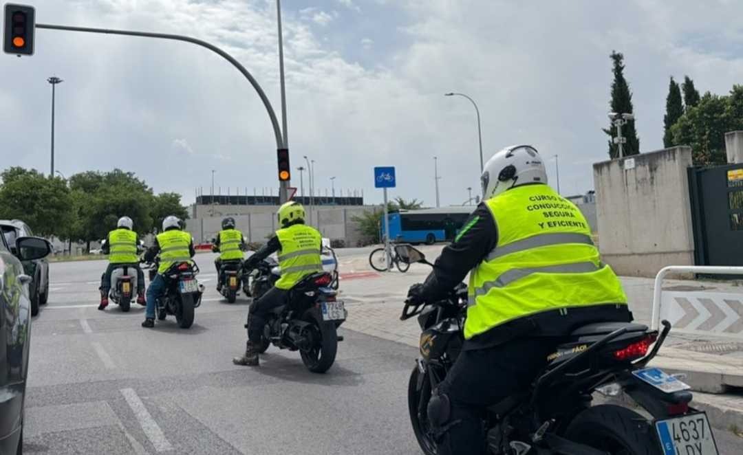 Motociclistas de un curso parados en un semáforo